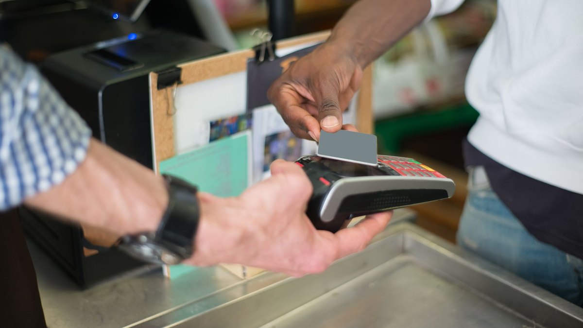 Traveller tapping a bank card at a ferry pier gate in Hong Kong