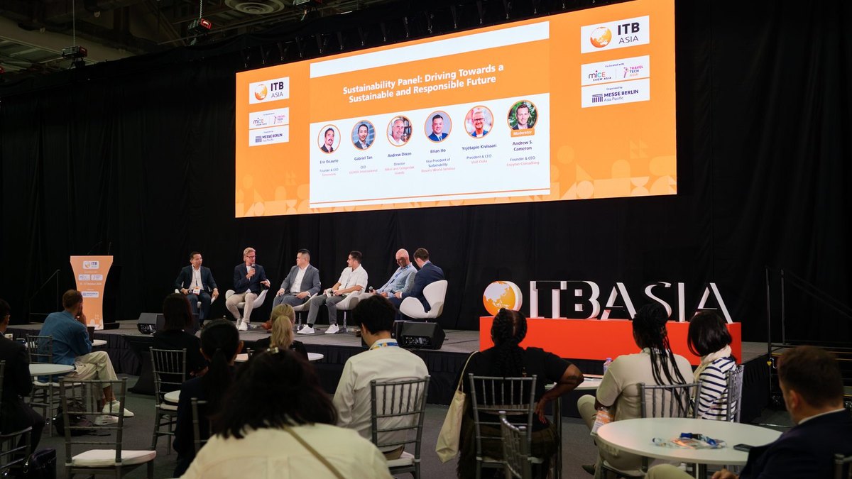 Audience watching a speaker on a technology stage at a travel trade show in Singapore